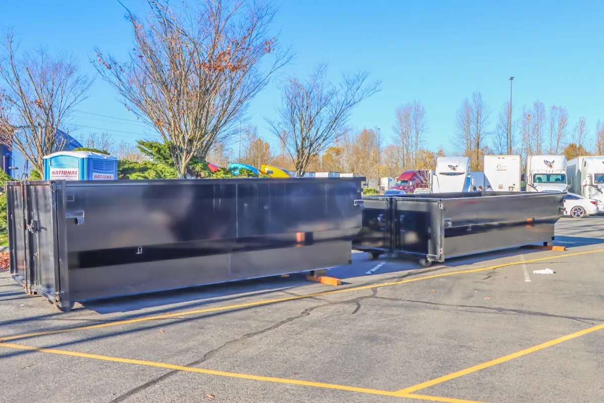 Professional dumpster rental service with roll-off container on residential driveway in South Patrick Shores
